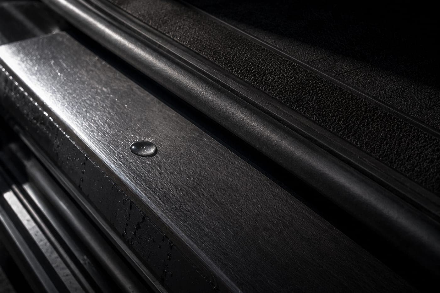 Close detail of a vehicle door sill and step